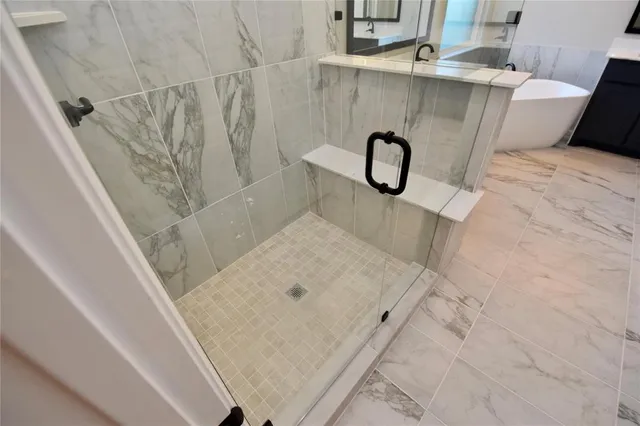 a bathroom with a double vanity sink mirror and shower