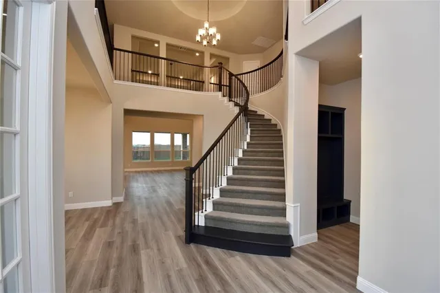 a view of entryway and hall with wooden floor