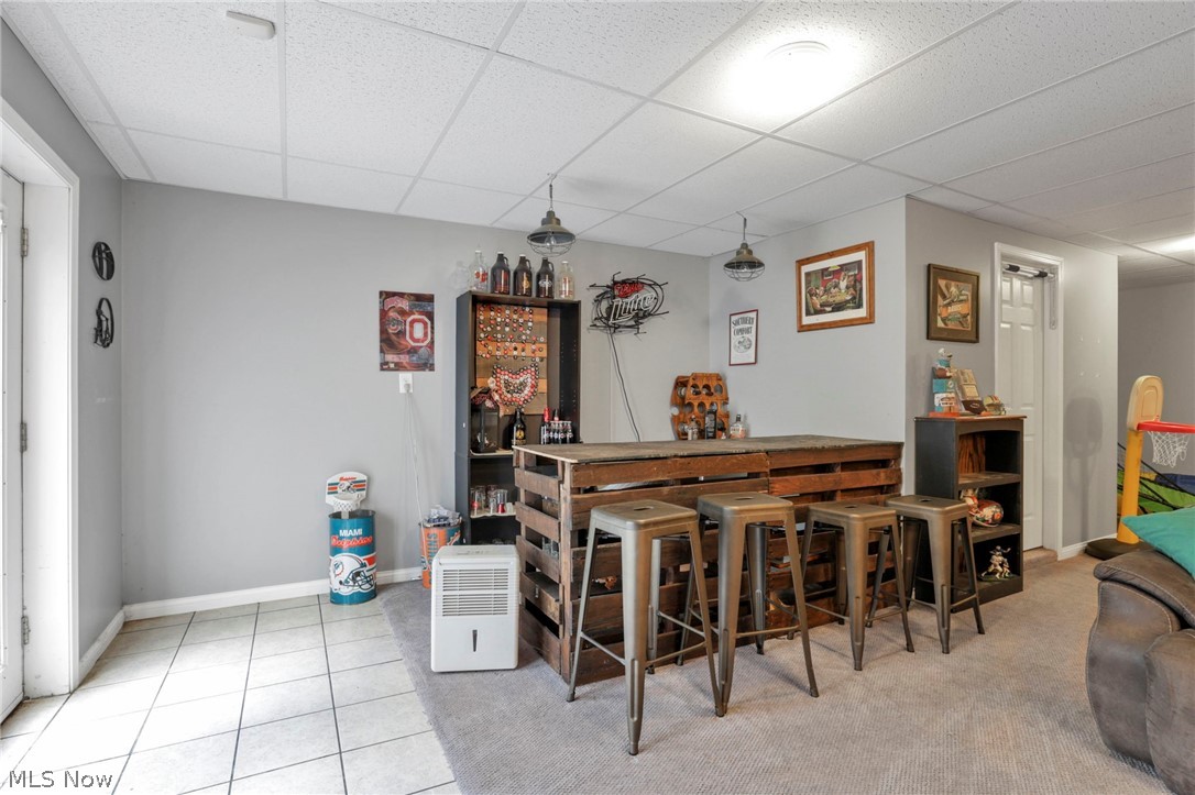 3483 Cooper Road Cumberland, OH 43732 - Photo 34 of 50 Bar featuring light tile flooring and a drop ceiling