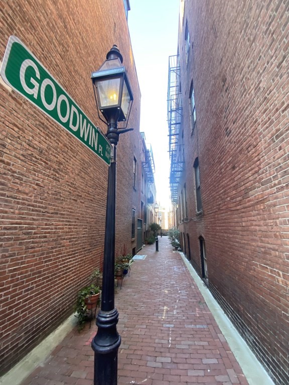 a street sign on a brick wall