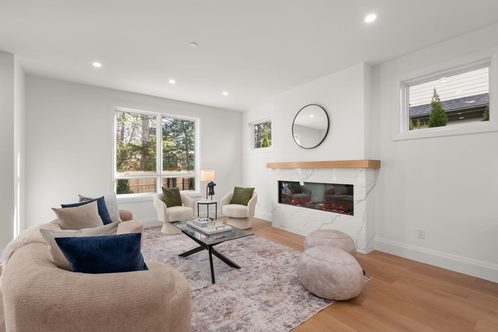 956 Walnut Street, Unit 5 Newton, MA 02459 - Photo 14 of 38 a living room with furniture and a fireplace