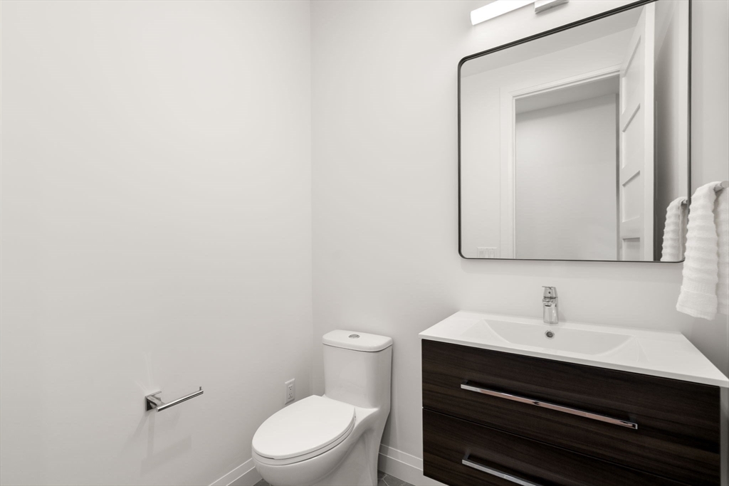 956 Walnut Street, Unit 5 Newton, MA 02459 - Photo 18 of 38 a bathroom with a toilet sink and mirror