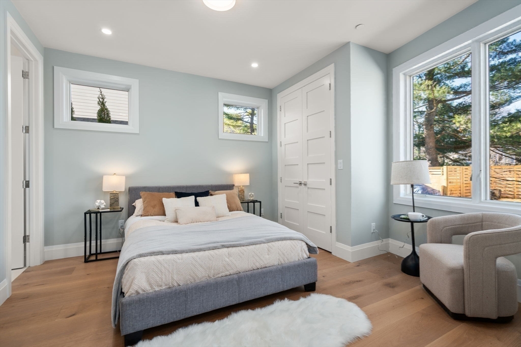 956 Walnut Street, Unit 5 Newton, MA 02459 - Photo 19 of 38 a bedroom with a bed and a couch