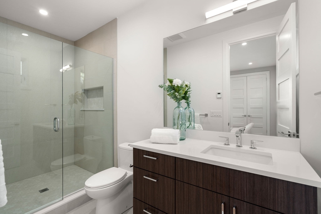 956 Walnut Street, Unit 5 Newton, MA 02459 - Photo 20 of 38 a bathroom with a sink shower and a toilet