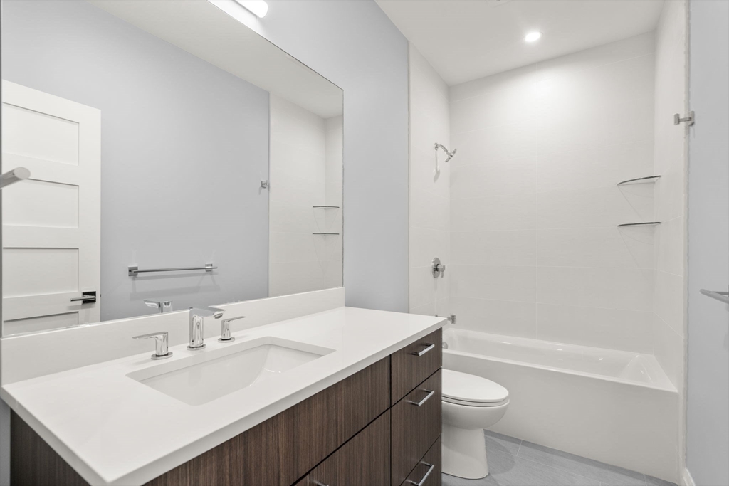 956 Walnut Street, Unit 5 Newton, MA 02459 - Photo 26 of 38 a bathroom with a sink a toilet and shower