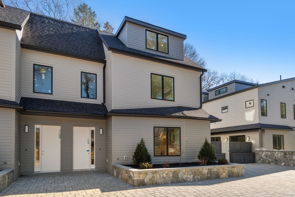 956 Walnut Street, Unit 5 Newton, MA 02459 - Photo 3 of 38 a front view of a house with garage