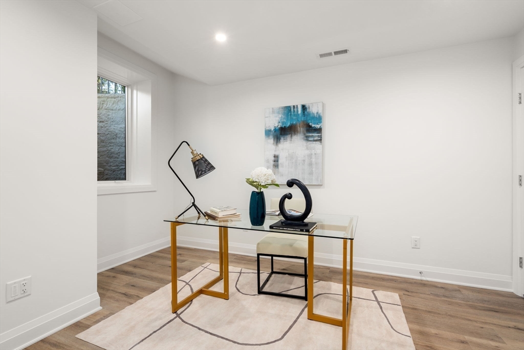 956 Walnut Street, Unit 5 Newton, MA 02459 - Photo 32 of 38 a living room with gym equipment and wooden floor