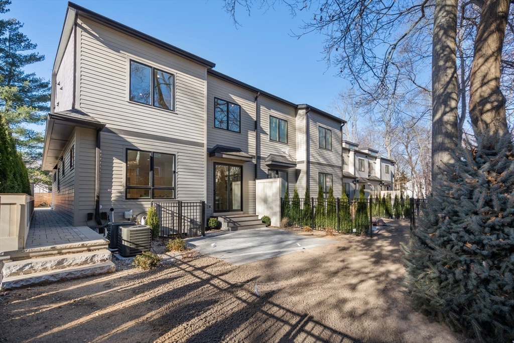 956 Walnut Street, Unit 5 Newton, MA 02459 - Photo 35 of 38 a view of a house with a yard