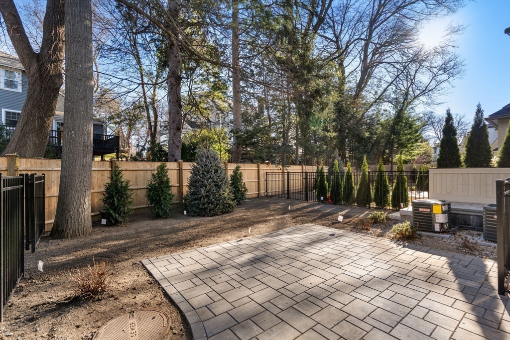 956 Walnut Street, Unit 5 Newton, MA 02459 - Photo 38 of 38 a backyard of a house with barbeque oven and outdoor seating