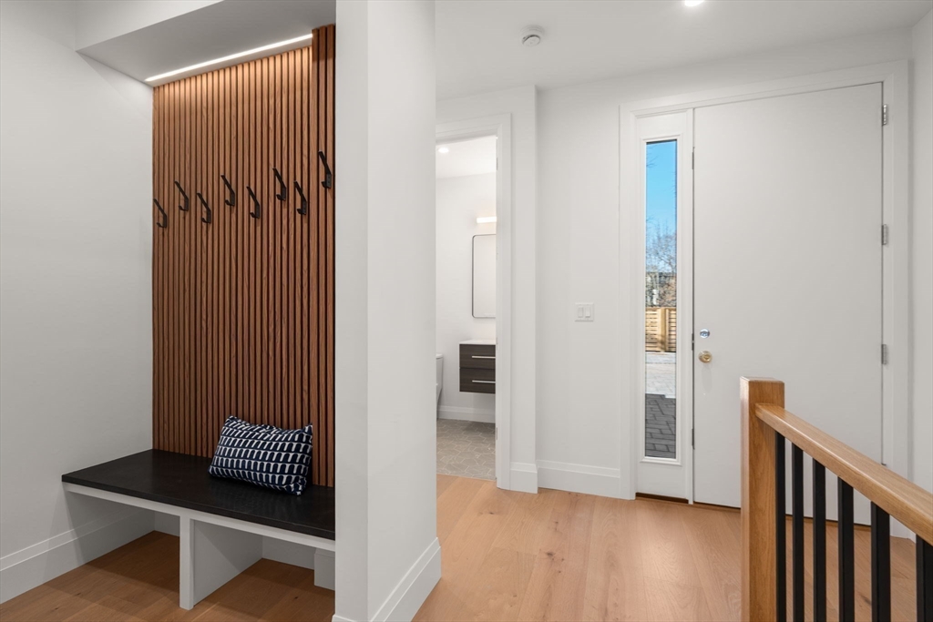 956 Walnut Street, Unit 5 Newton, MA 02459 - Photo 4 of 38 a view of a hallway with wooden floor and closet
