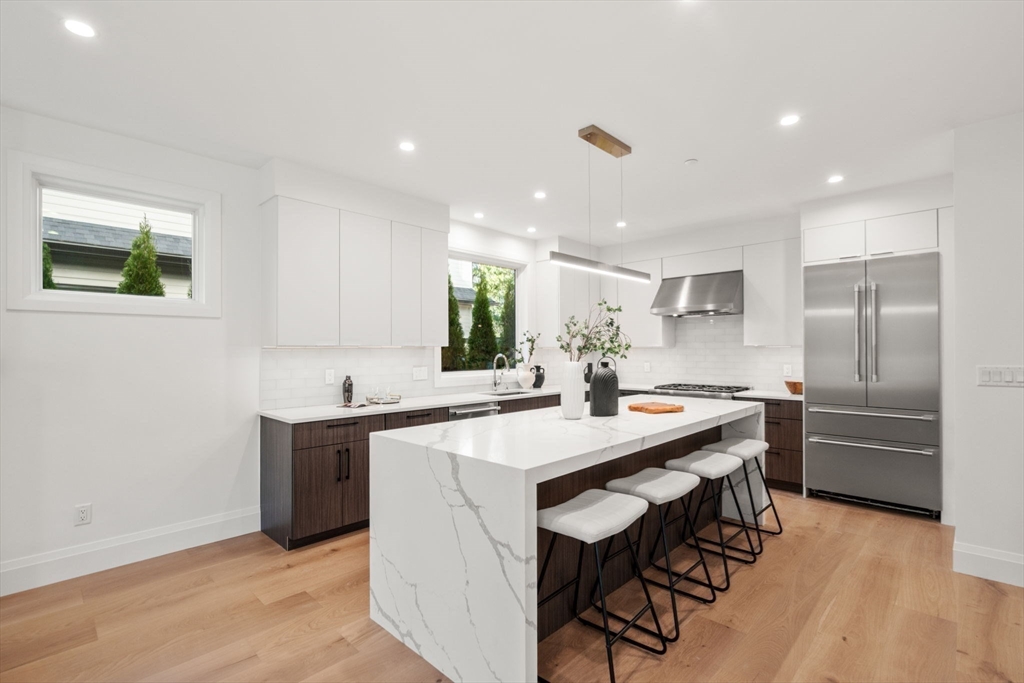 956 Walnut Street, Unit 5 Newton, MA 02459 - Photo 8 of 38 a kitchen with stainless steel appliances a sink and a refrigerator