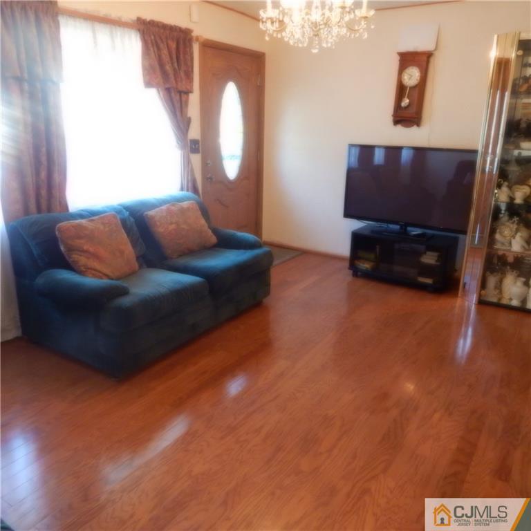 23 Idlewild Road Edison, NJ 08817 - Photo 2 of 19 a living room with furniture and a flat screen tv