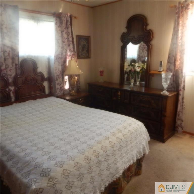 23 Idlewild Road Edison, NJ 08817 - Photo 14 of 19 a bedroom with a bed and a mirror