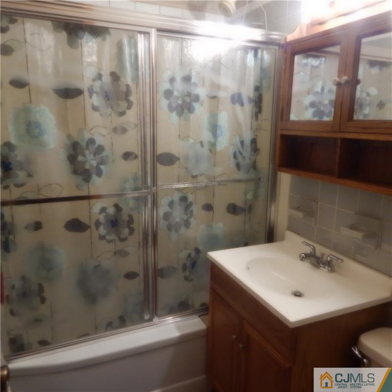 23 Idlewild Road Edison, NJ 08817 - Photo 15 of 19 a bathroom with a sink and mirror