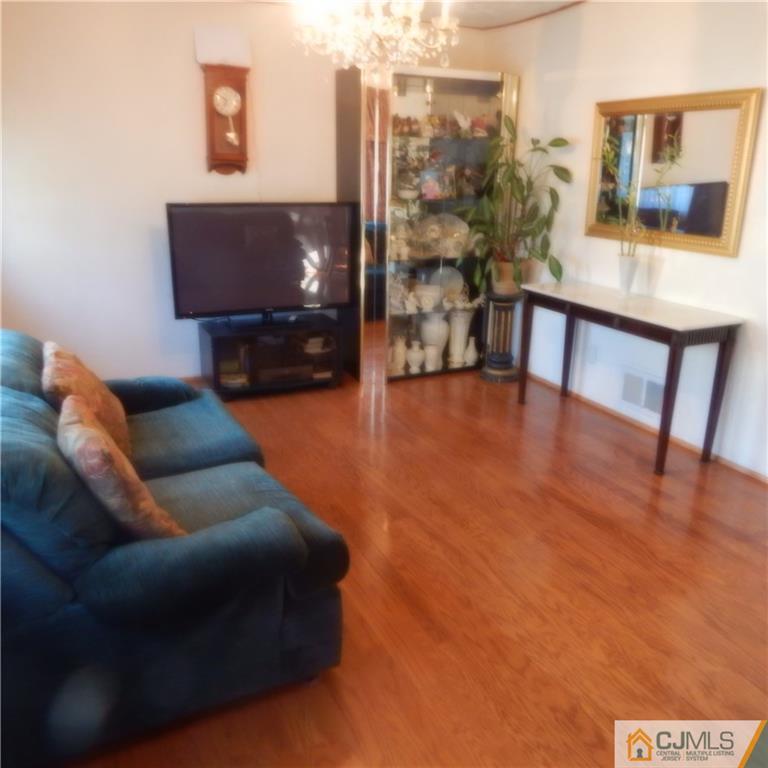 23 Idlewild Road Edison, NJ 08817 - Photo 3 of 19 a living room with furniture and a flat screen tv