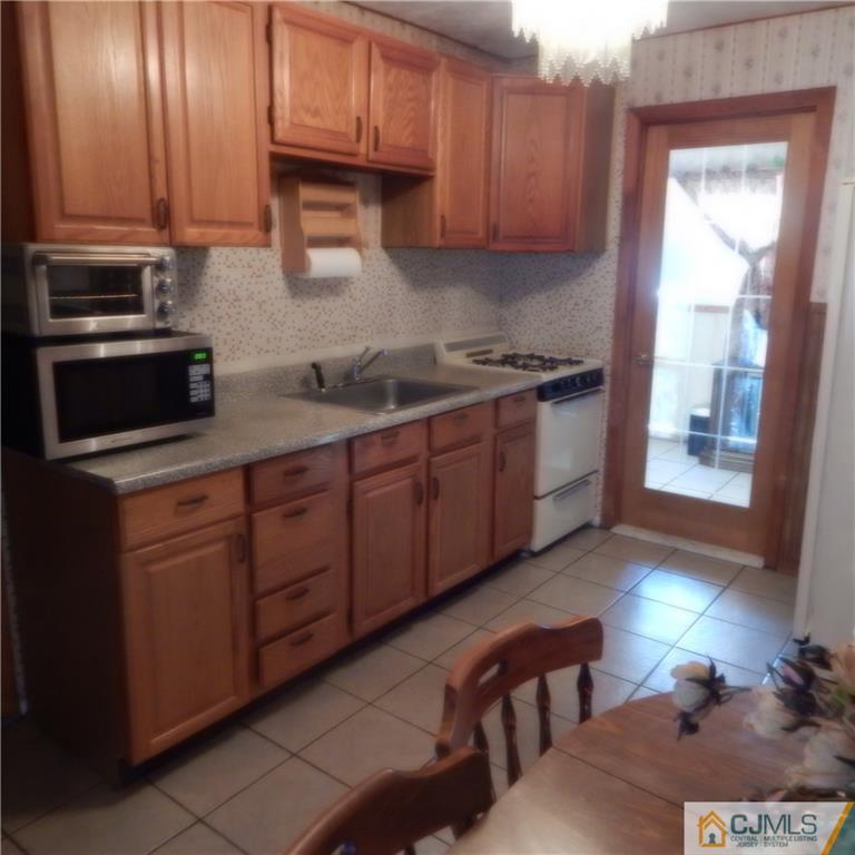 23 Idlewild Road Edison, NJ 08817 - Photo 6 of 19 a kitchen with stainless steel appliances granite countertop a sink a stove and a refrigerator