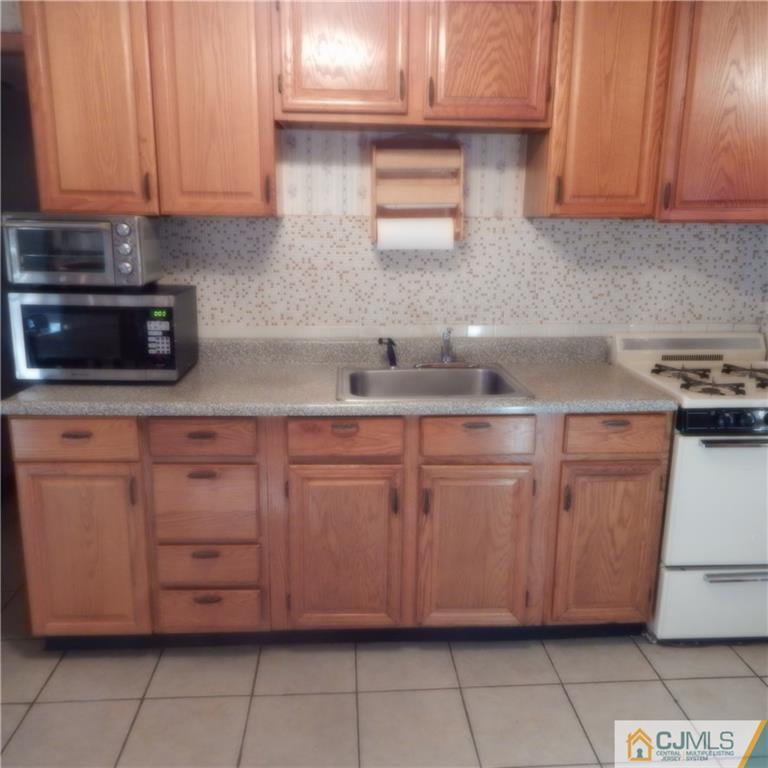 23 Idlewild Road Edison, NJ 08817 - Photo 7 of 19 a kitchen with stainless steel appliances granite countertop a sink a stove and dishwasher