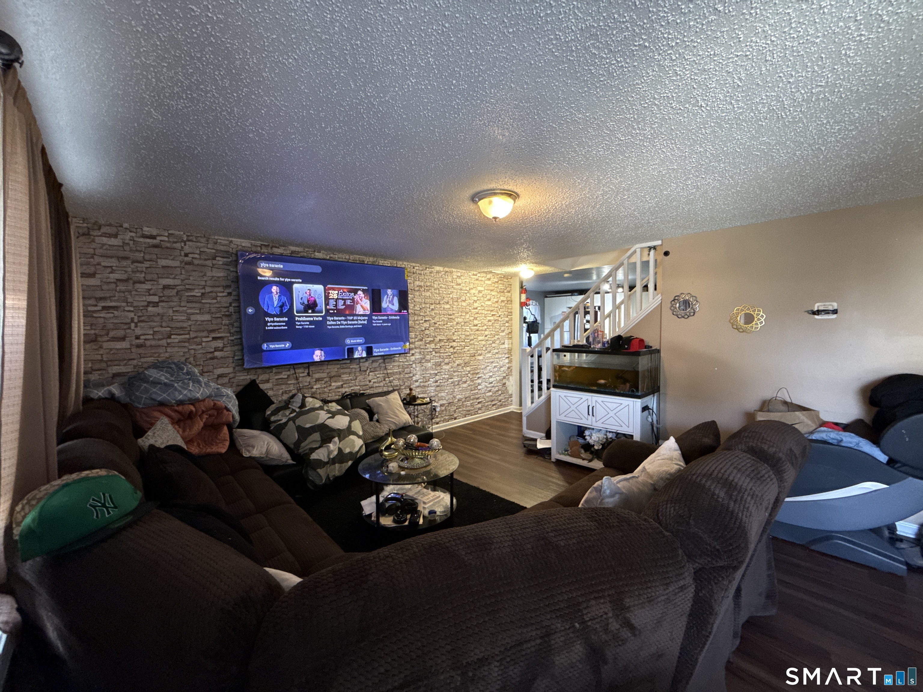 27-29 McLaughlin Terrace Derby, CT 06418 - Photo 3 of 16 a living room with furniture a rug and a projector