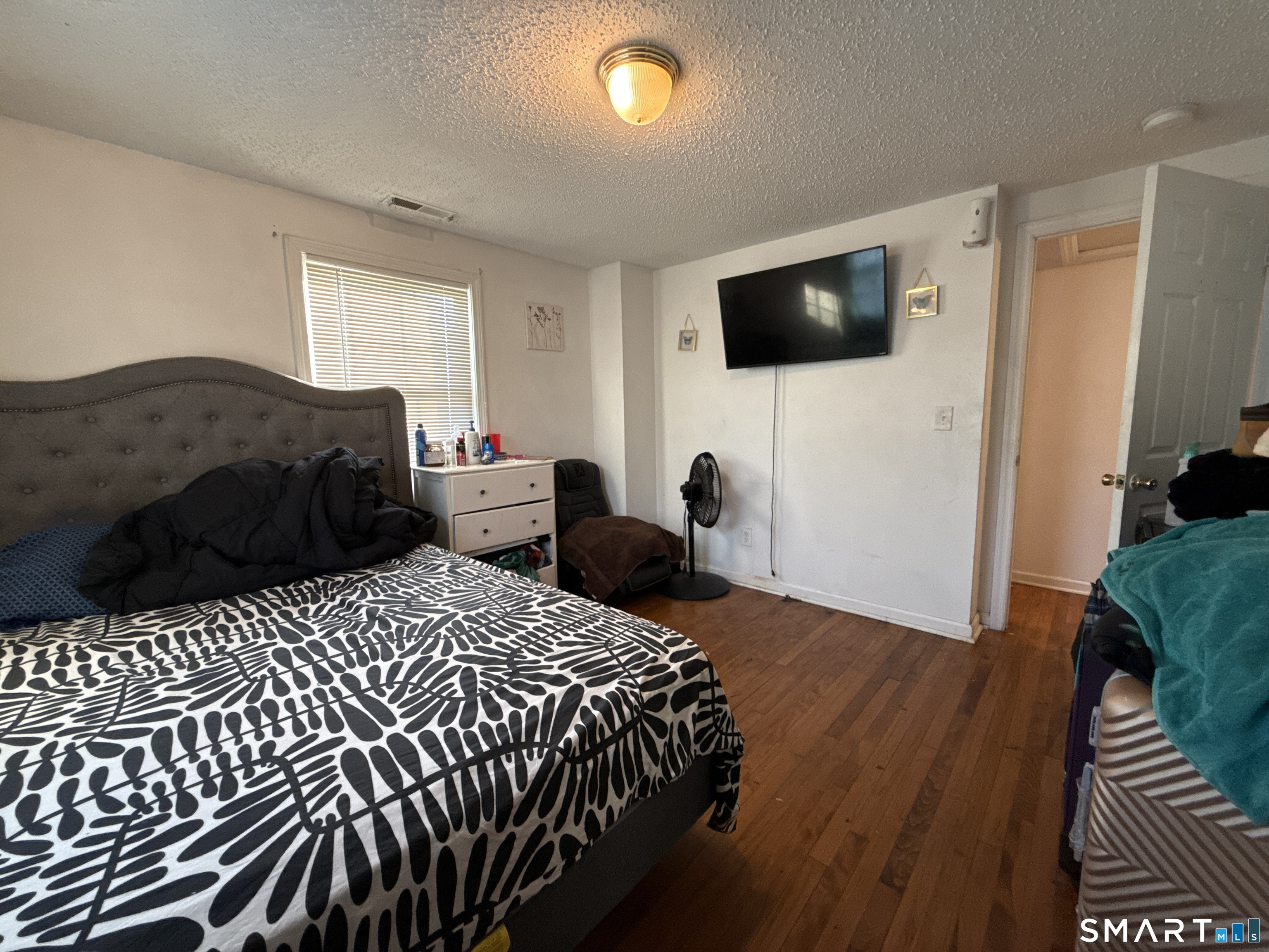 27-29 McLaughlin Terrace Derby, CT 06418 - Photo 10 of 16 a bedroom with a bed and a flat screen tv