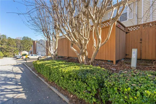 a view of a backyard with large trees