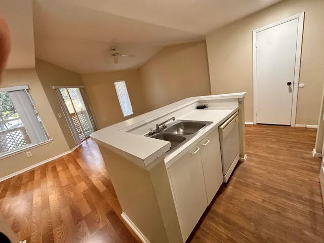 a utility room with wooden floor washer and dryer
