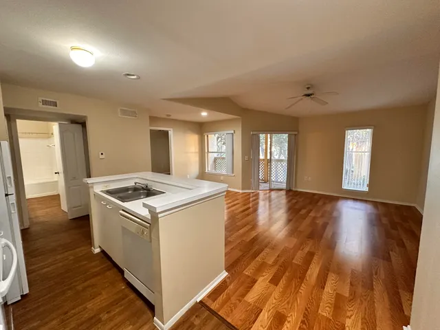 a view of a kitchen counter space and wooden floor
