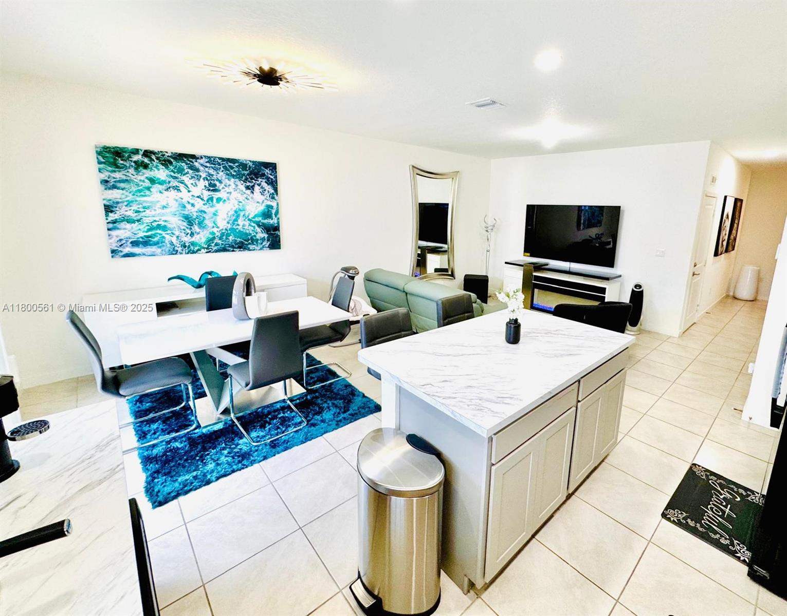 761 Southwest 11th Street, Unit 761 Florida City, FL 33034 - Photo 14 of 18 a living room with furniture and a flat screen tv