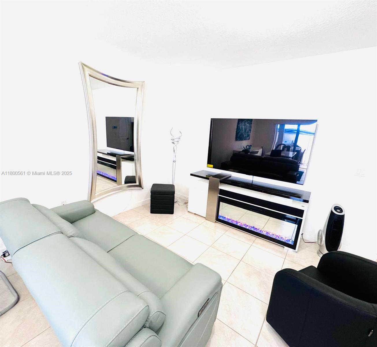 761 Southwest 11th Street, Unit 761 Florida City, FL 33034 - Photo 3 of 18 a living room with furniture and a flat screen tv