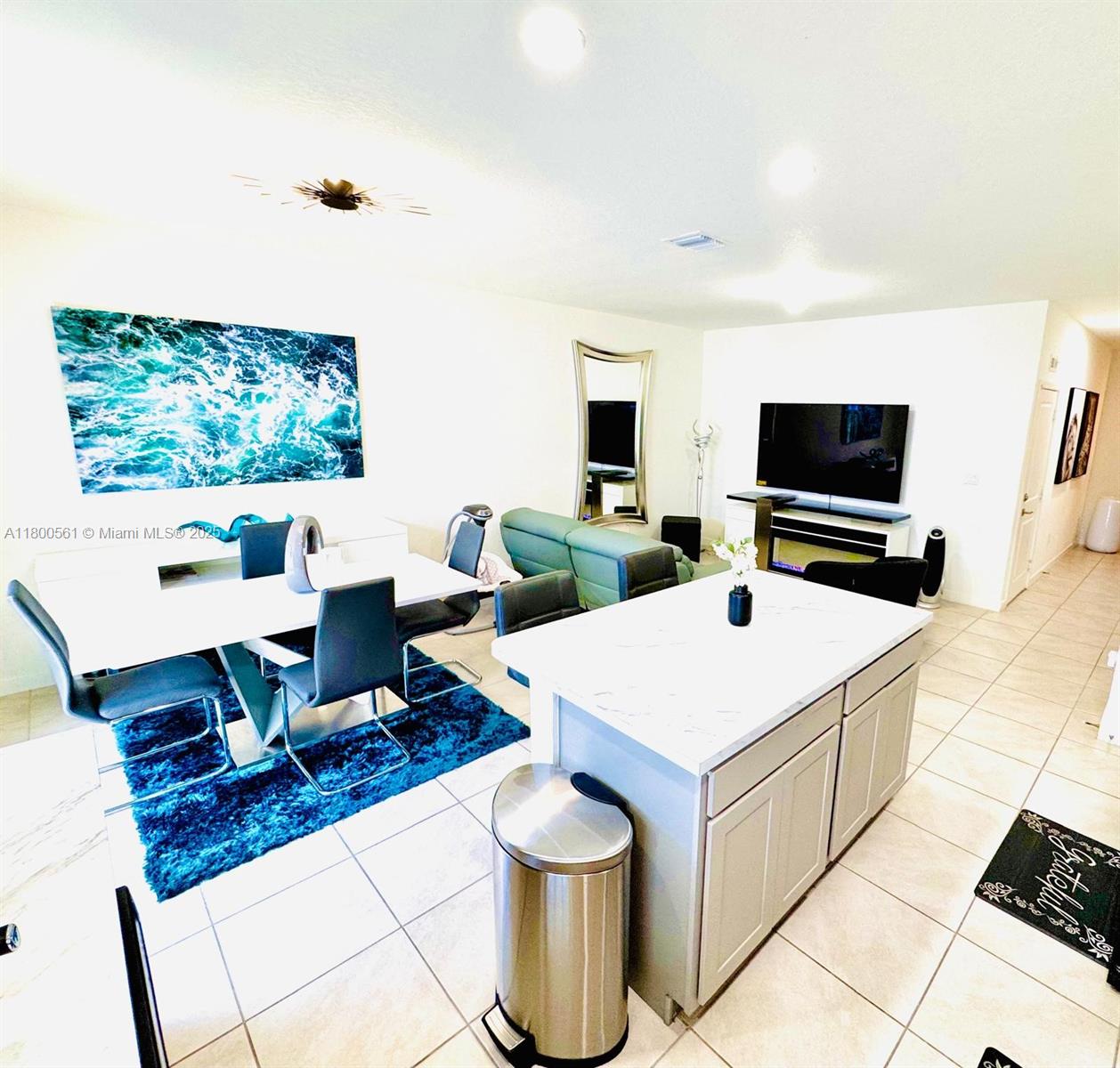761 Southwest 11th Street, Unit 761 Florida City, FL 33034 - Photo 5 of 18 a living room with stainless steel appliances furniture and a flat screen tv