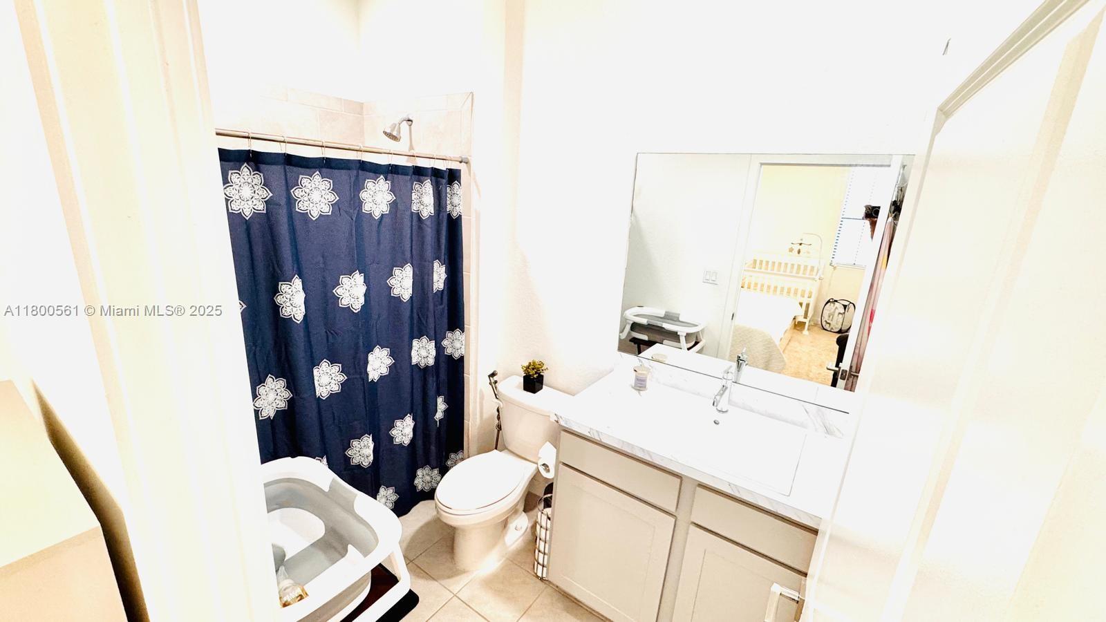 761 Southwest 11th Street, Unit 761 Florida City, FL 33034 - Photo 8 of 18 a bathroom with a sink vanity mirror and toilet