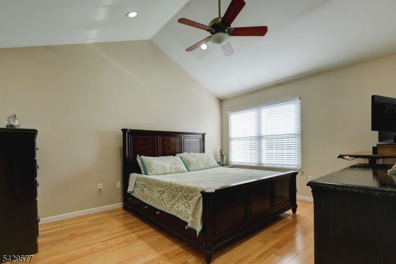 115 Constitution Way Bernards, NJ 07920 - Photo 18 of 31 a bedroom with a bed and a flat tv screen on dresser