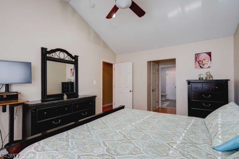 115 Constitution Way Bernards, NJ 07920 - Photo 19 of 31 a bedroom with a bed and a flat tv screen on dresser
