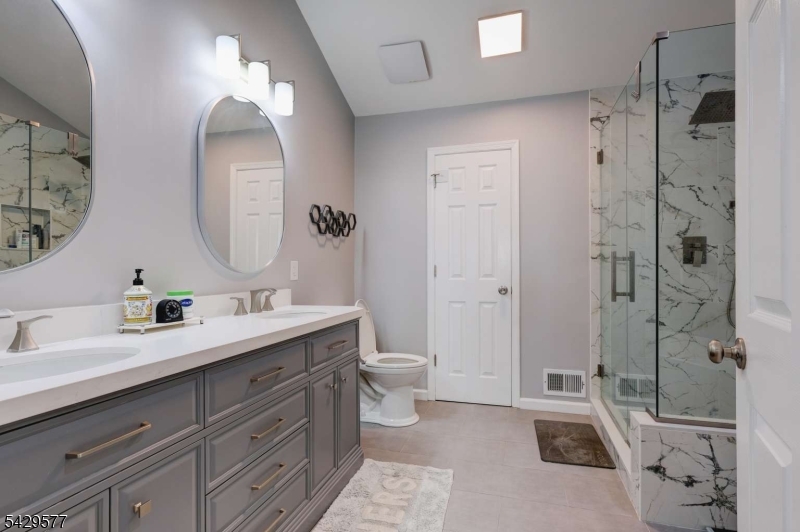 115 Constitution Way Bernards, NJ 07920 - Photo 21 of 31 a spacious bathroom with a double vanity sink toilet mirror and bathtub