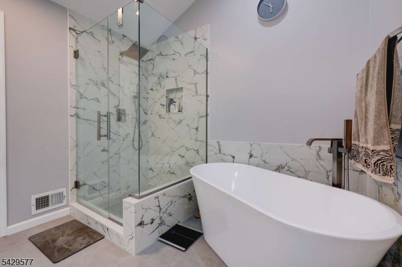 115 Constitution Way Bernards, NJ 07920 - Photo 22 of 31 a white bath tub sitting next to a white sink and vanity