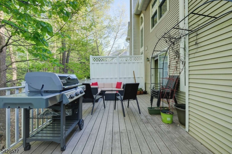115 Constitution Way Bernards, NJ 07920 - Photo 26 of 31 a view of deck with table and chairs and wooden floor