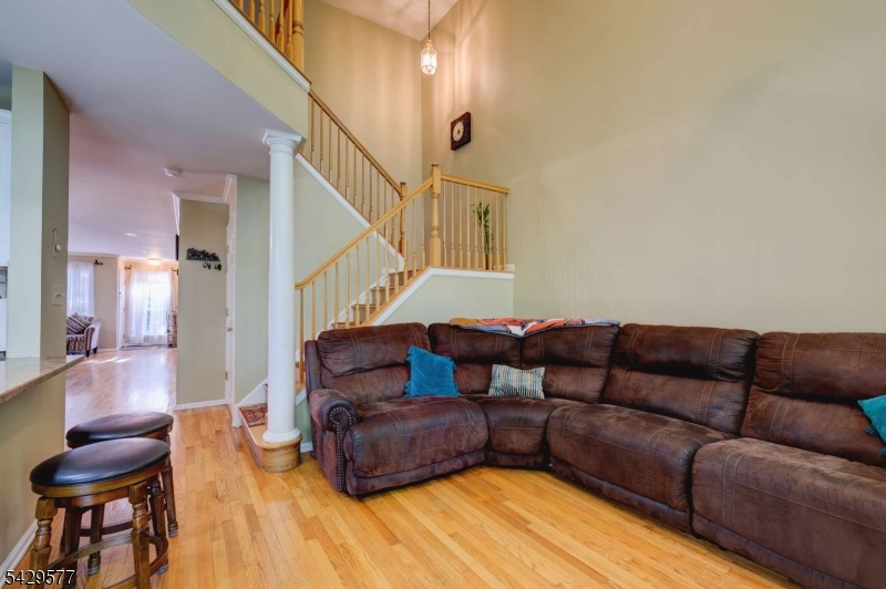 115 Constitution Way Bernards, NJ 07920 - Photo 9 of 31 a living room with furniture and a wooden floor