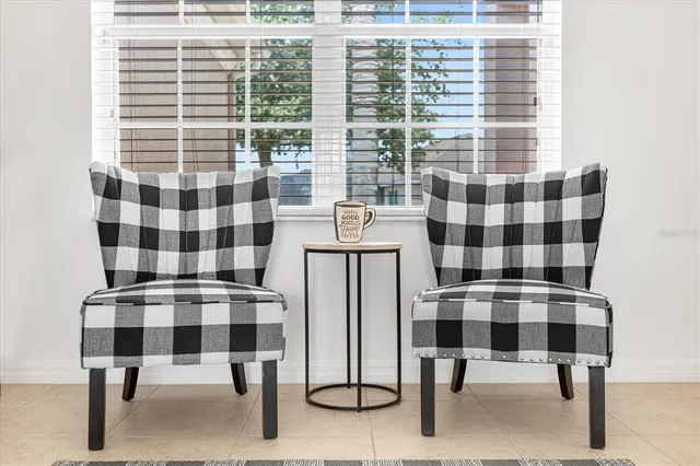 a kitchen with a sink dishwasher and white cabinets with wooden floor