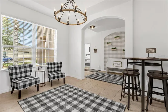 a kitchen with white cabinets and refrigerator