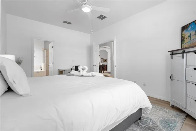 a spacious bedroom with a bed and a window