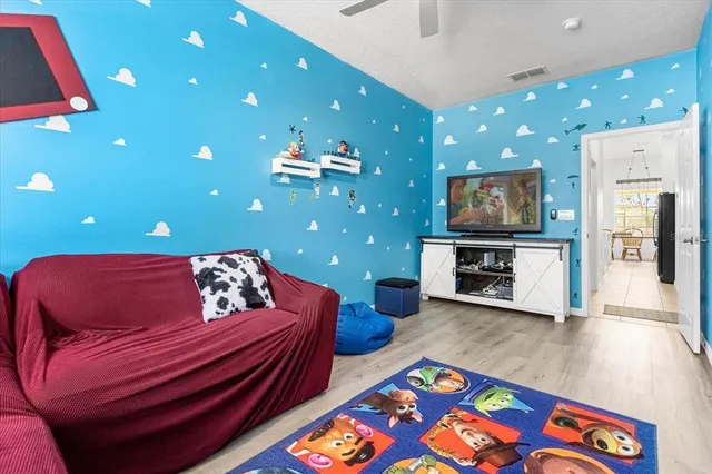 a bedroom with a bed and a flat screen tv