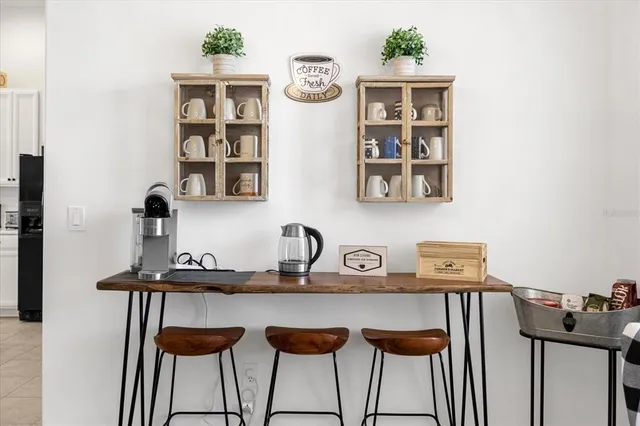 a kitchen with stainless steel appliances kitchen island granite countertop a kitchen island and chairs in it