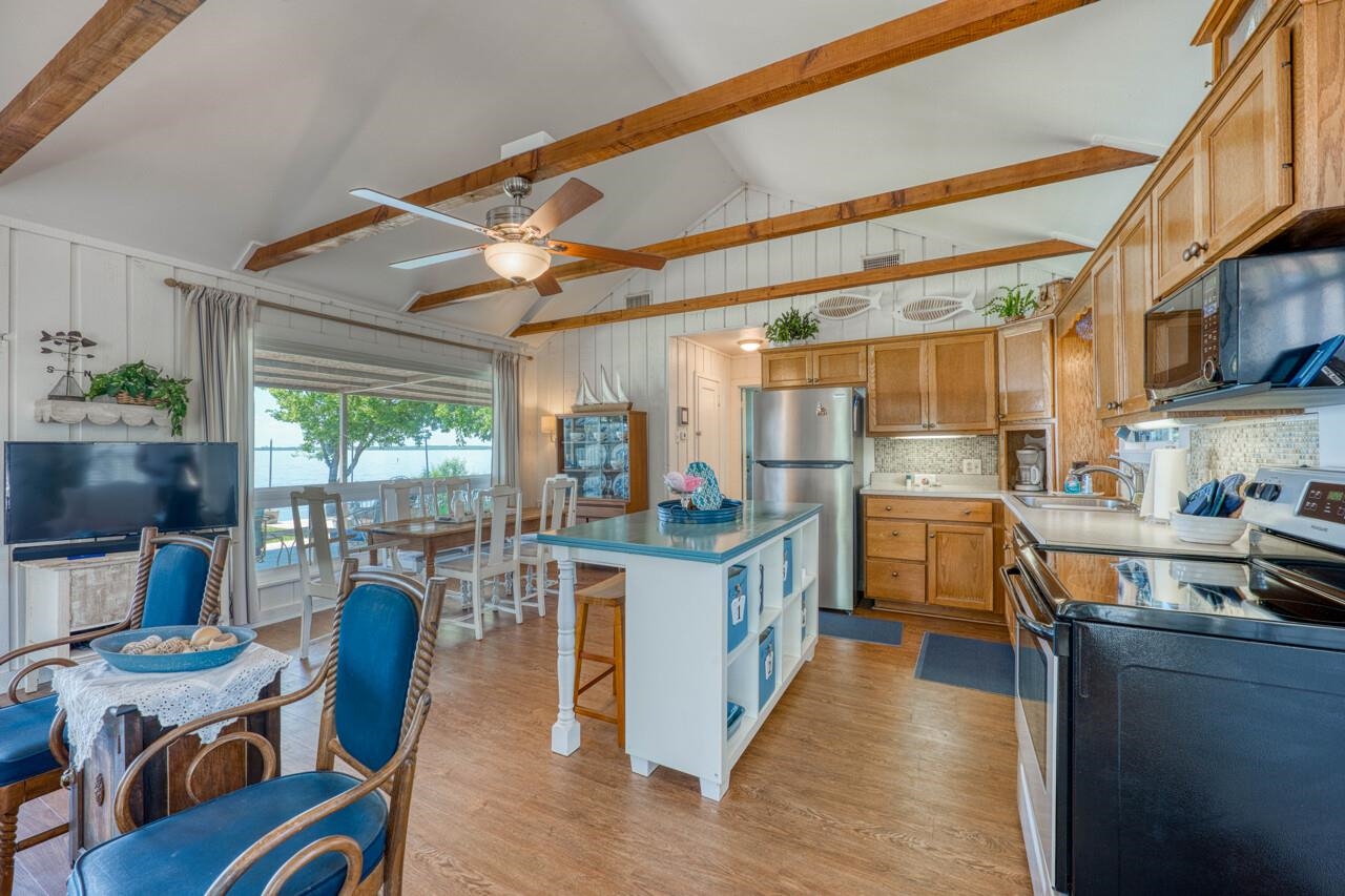 809 Lakeshore Loop Tow, TX 78672 - Photo 6 of 33 a kitchen with stainless steel appliances granite countertop a stove and a refrigerator
