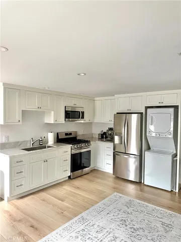 a kitchen with stainless steel appliances granite countertop a refrigerator sink and stove