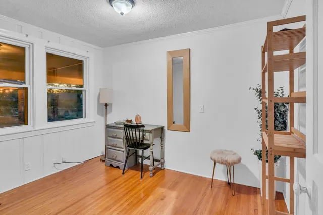 a work room with furniture and wooden floor