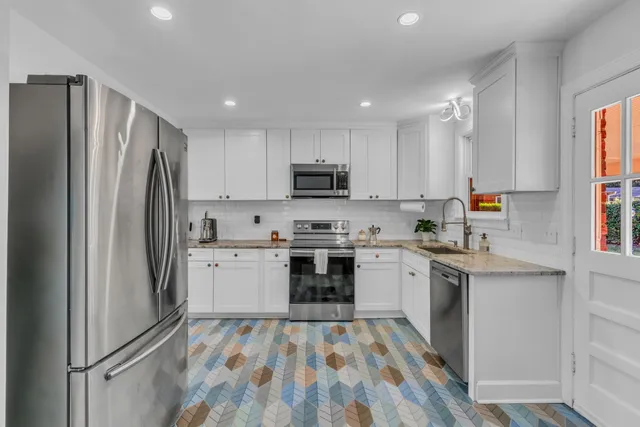 a kitchen with a refrigerator sink and microwave