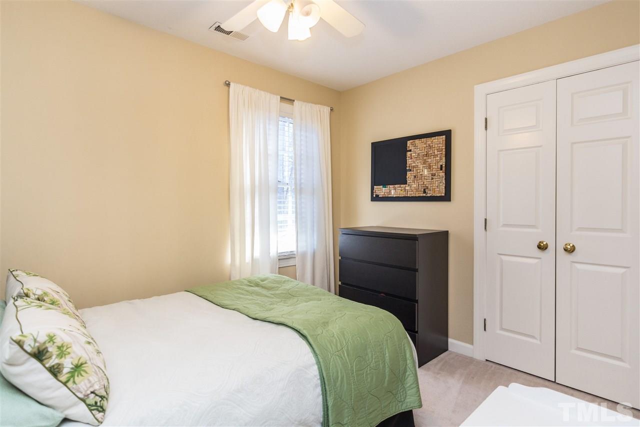18 Striding Ridge Court Durham, NC 27713 - Photo 12 of 22 a bedroom with a bed and a window