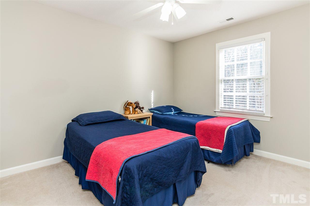 18 Striding Ridge Court Durham, NC 27713 - Photo 13 of 22 a bedroom with two beds and a window