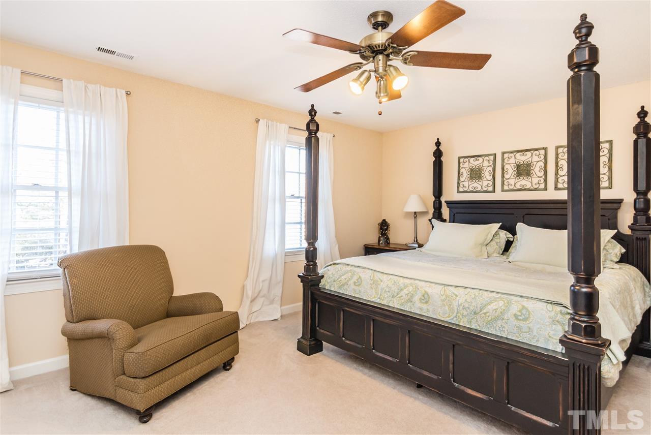 18 Striding Ridge Court Durham, NC 27713 - Photo 14 of 22 a bedroom with a bed couch and window