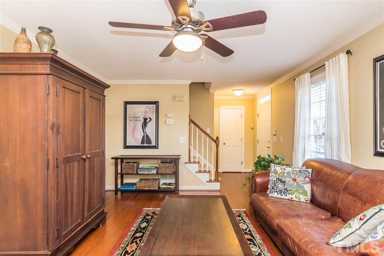 18 Striding Ridge Court Durham, NC 27713 - Photo 5 of 22 a living room with furniture and a chandelier