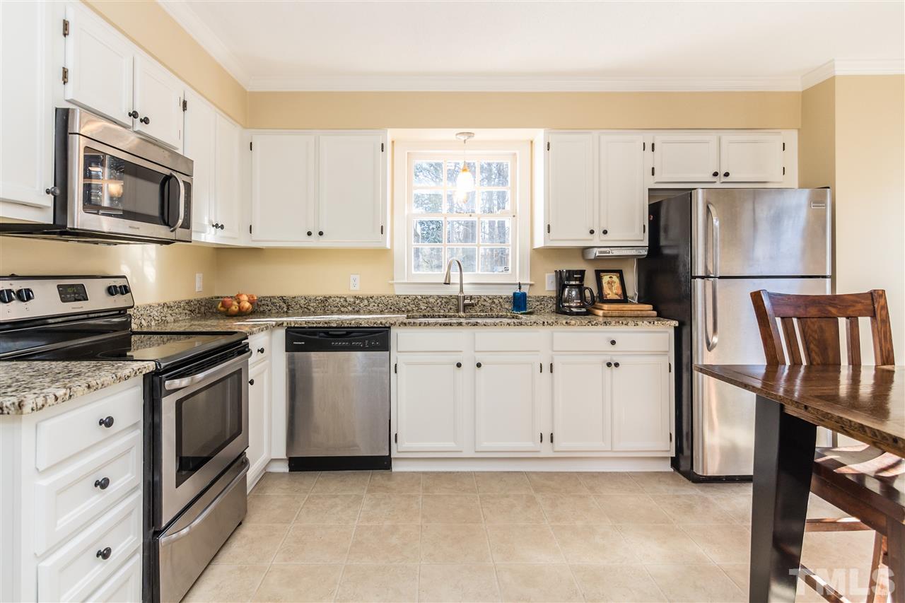 18 Striding Ridge Court Durham, NC 27713 - Photo 8 of 22 a kitchen with white cabinets and stainless steel appliances